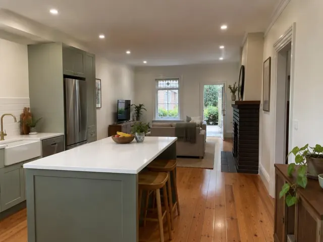 Open-plan home interior with recessed downlights, kitchen island and living area in Camperdown